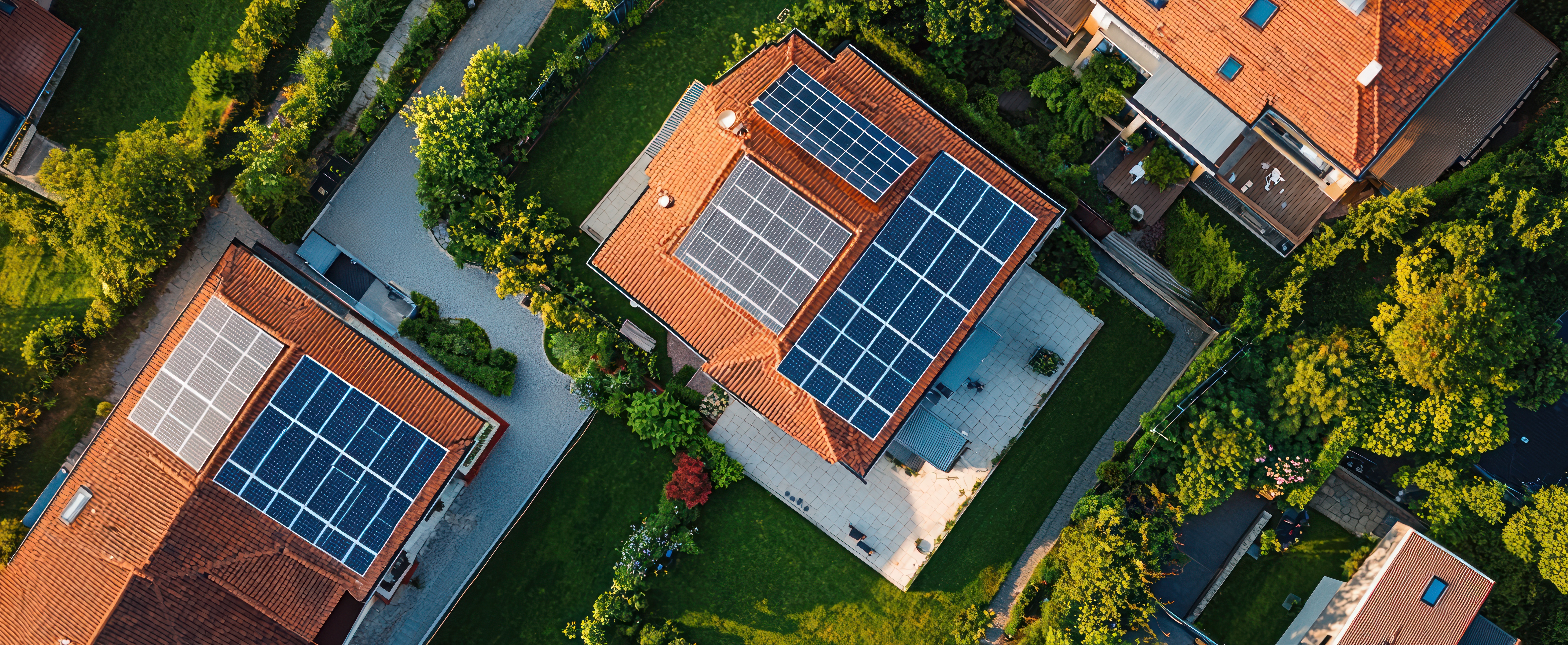 Aerial view of residential homes with solar panel installations